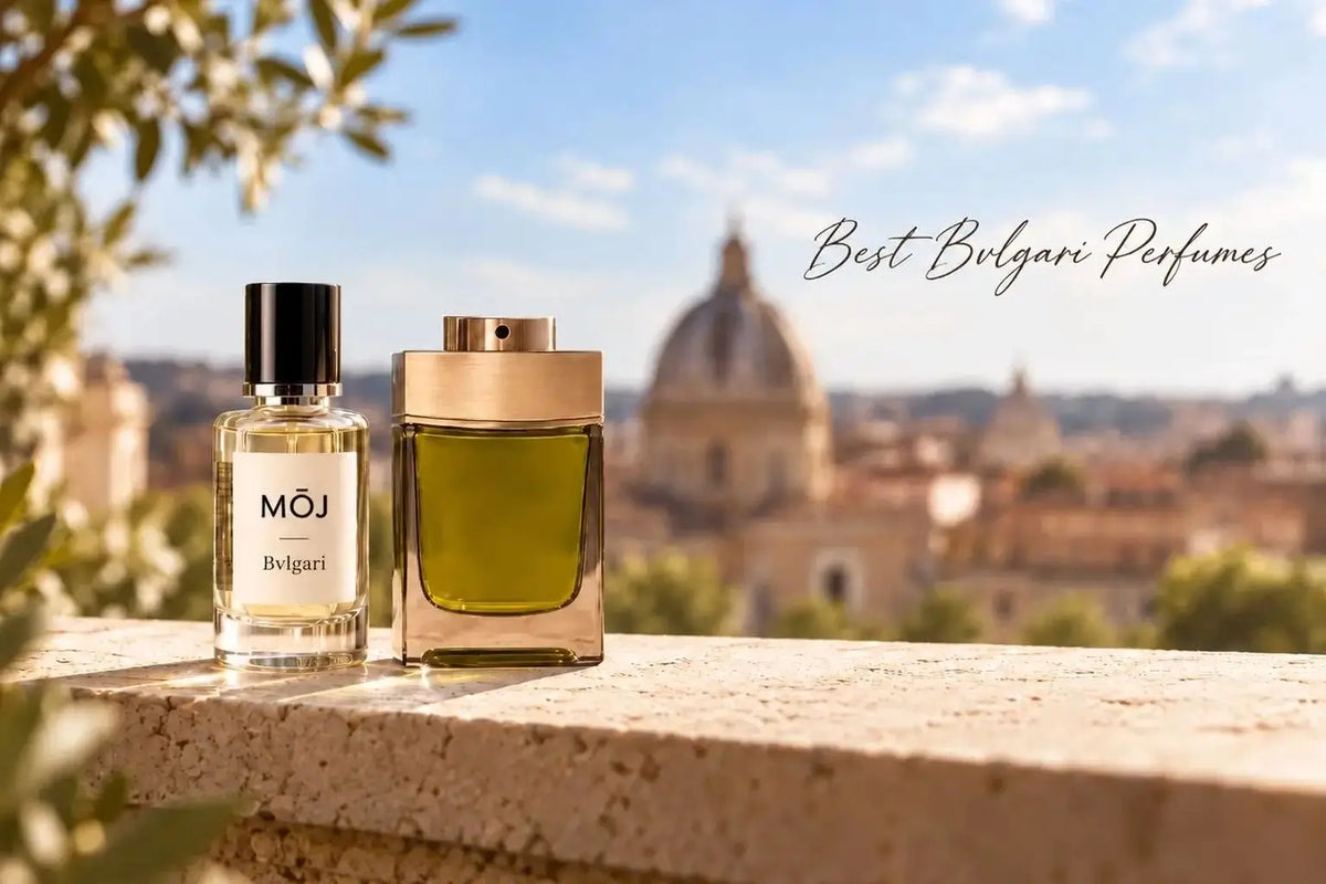 MOJ perfume bottle labelled Bvlgari beside a green glass bottle with a gold cap on a stone ledge above a blurred Rome skyline, with the words Best Bvlgari Perfumes