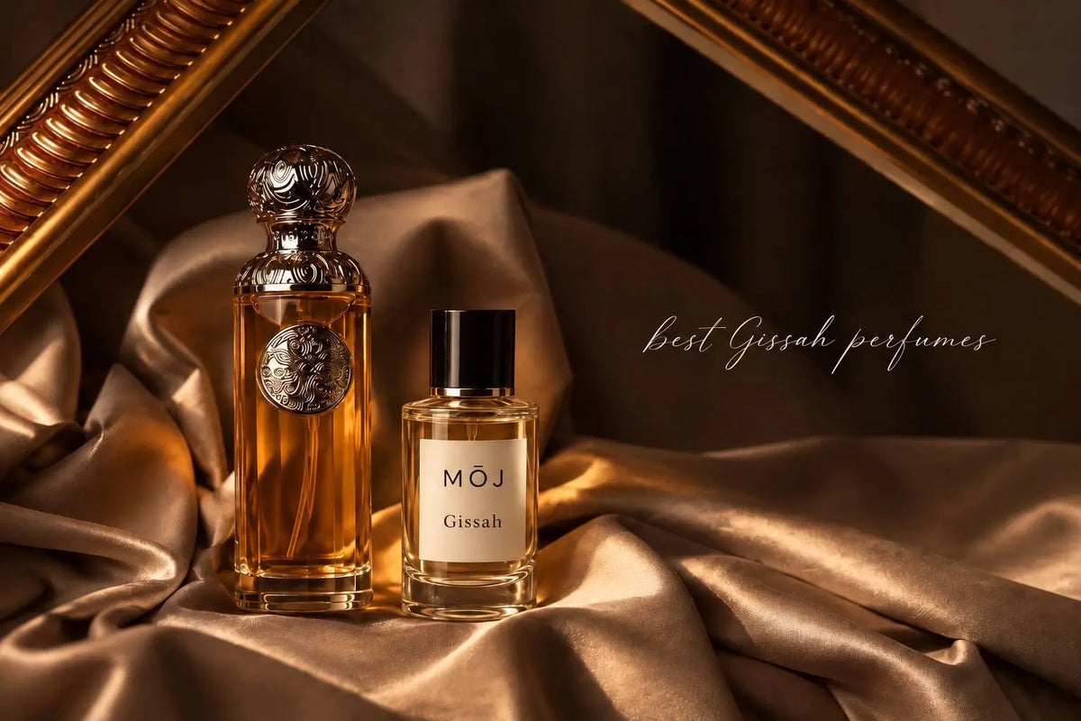 	MOJ Gissah inspired perfume beside a Gissah bottle with its filigree dome cap on gold satin