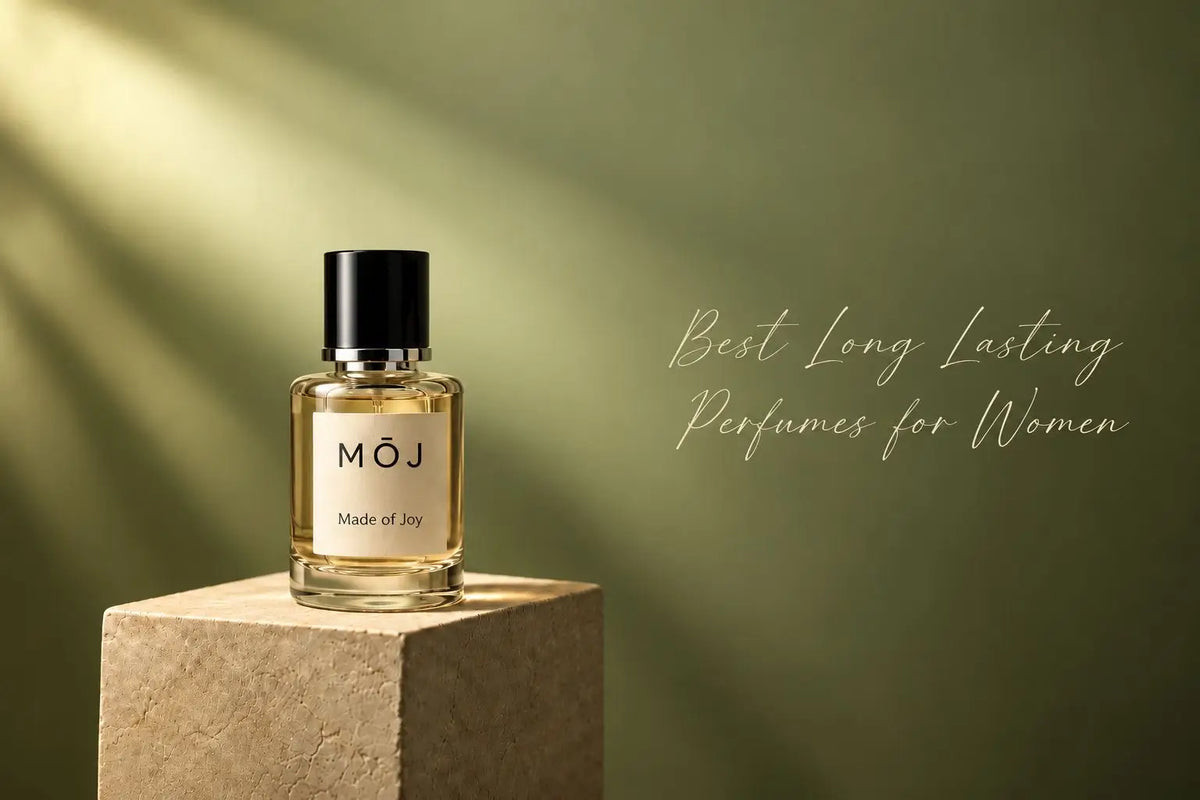 MOJ perfume bottle on a stone block against an olive green wall in soft sunlight, Best Long Lasting Perfumes for Women in the UAE