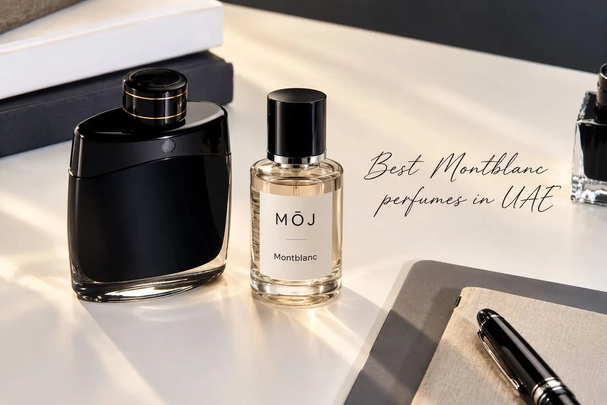 MOJ perfume bottle labelled Montblanc beside a black Montblanc Legend bottle on a desk with a fountain pen and notebook, best Montblanc perfumes in the UAE